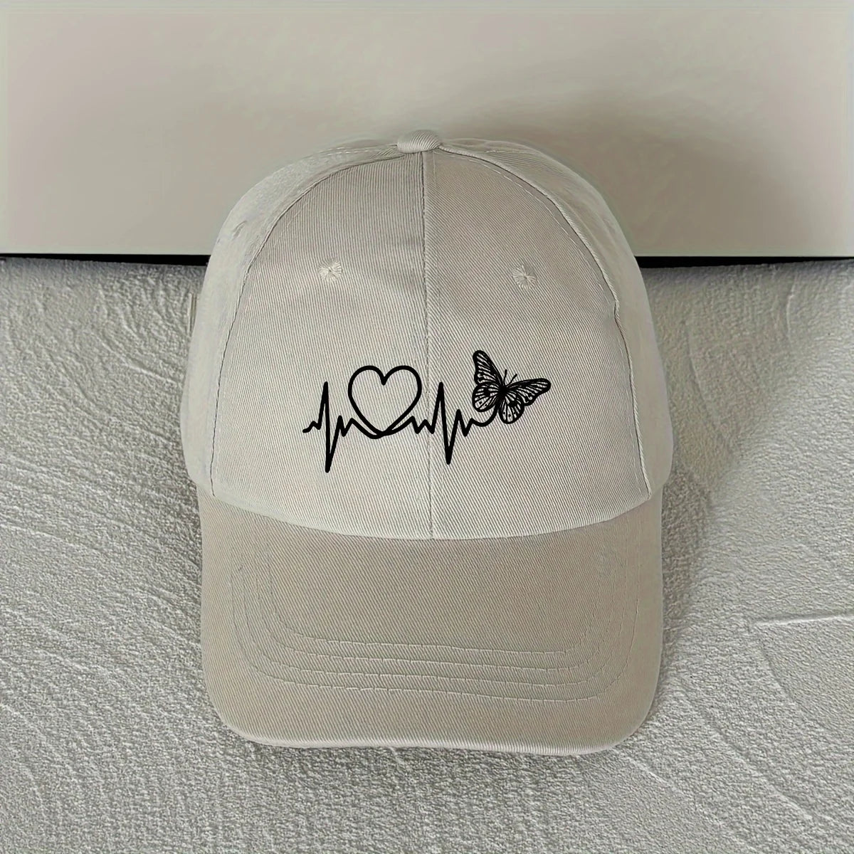 A Minimalist Baseball Cap with White Butterfly Heartbeat Print Design for Outdoor Sports