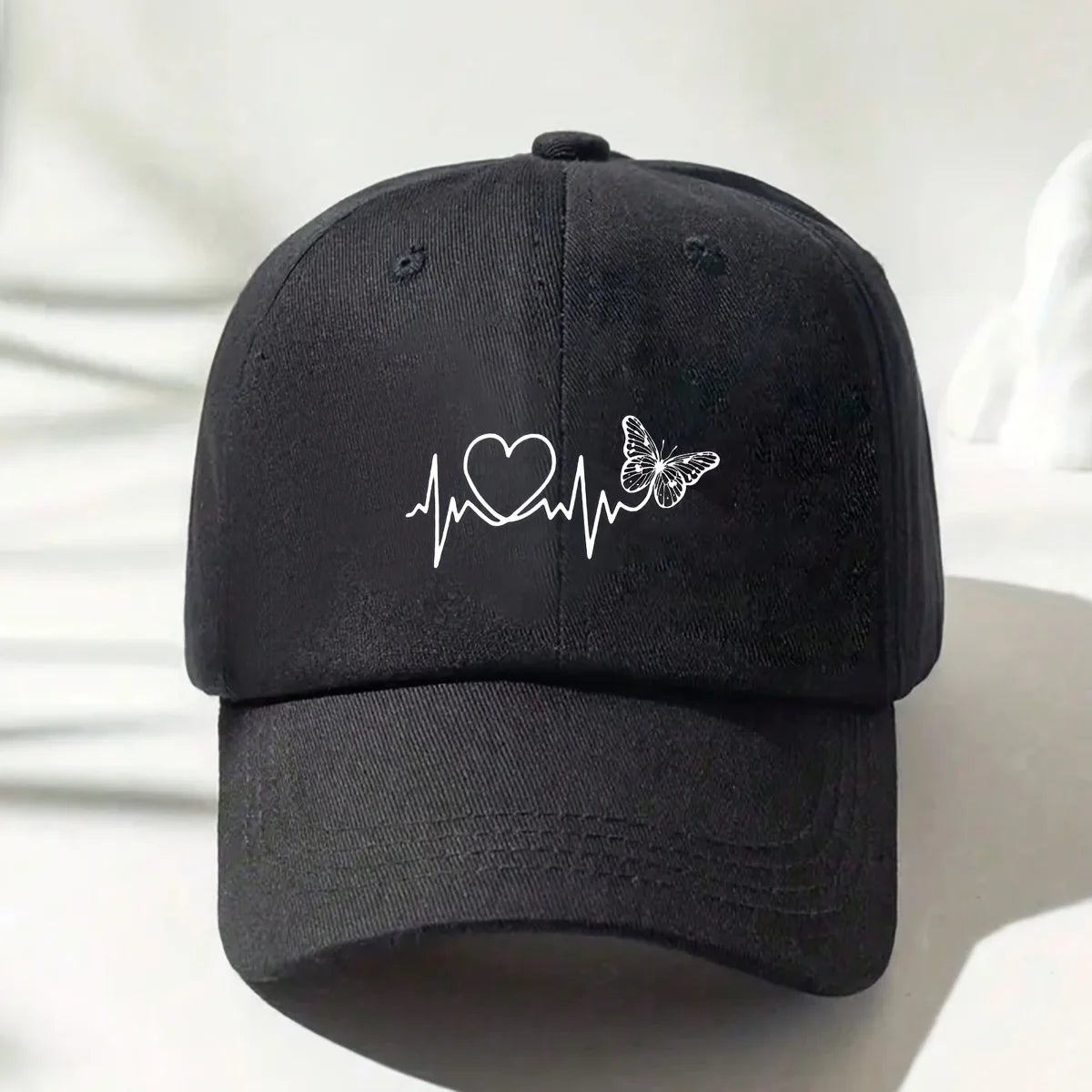 A Minimalist Baseball Cap with White Butterfly Heartbeat Print Design for Outdoor Sports