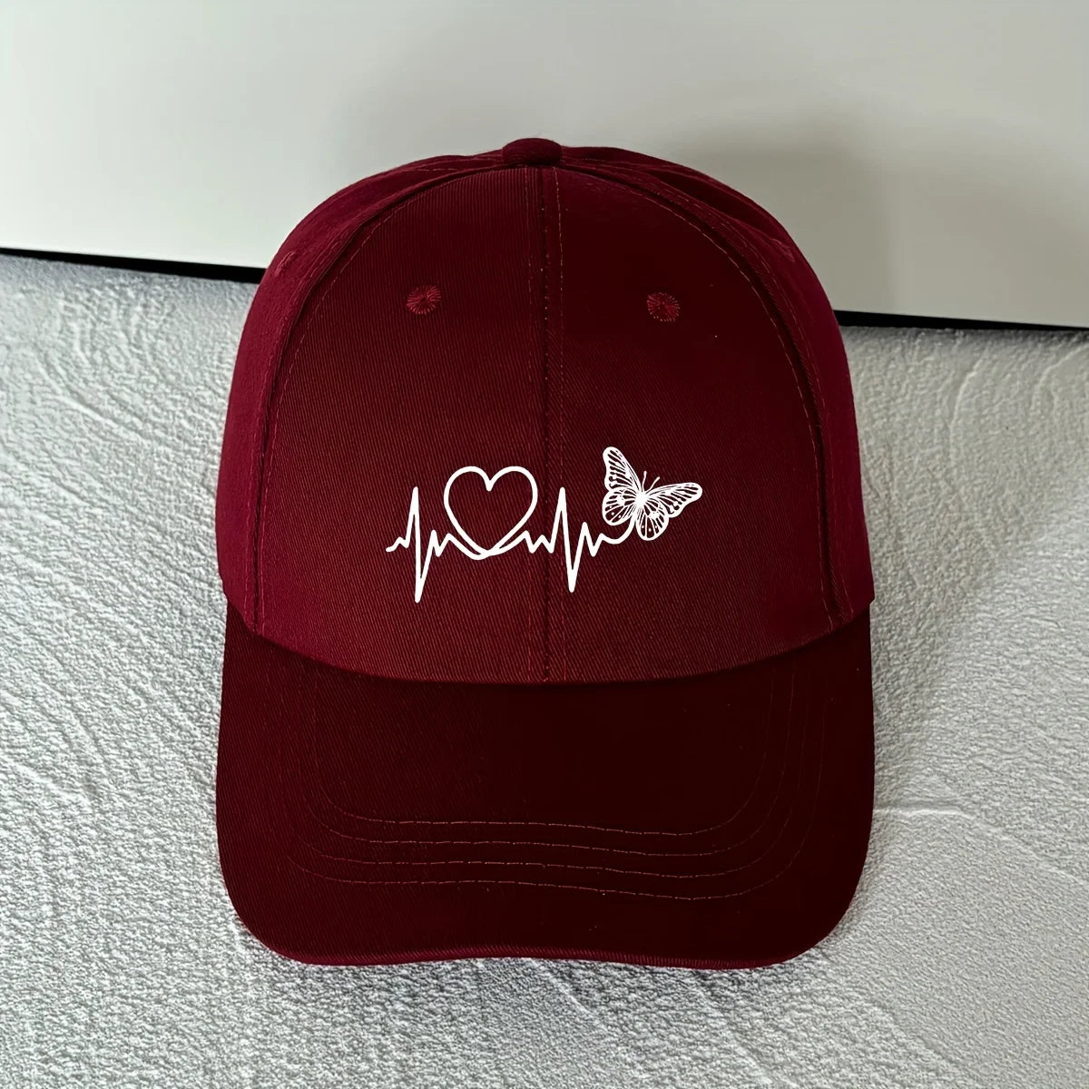 A Minimalist Baseball Cap with White Butterfly Heartbeat Print Design for Outdoor Sports
